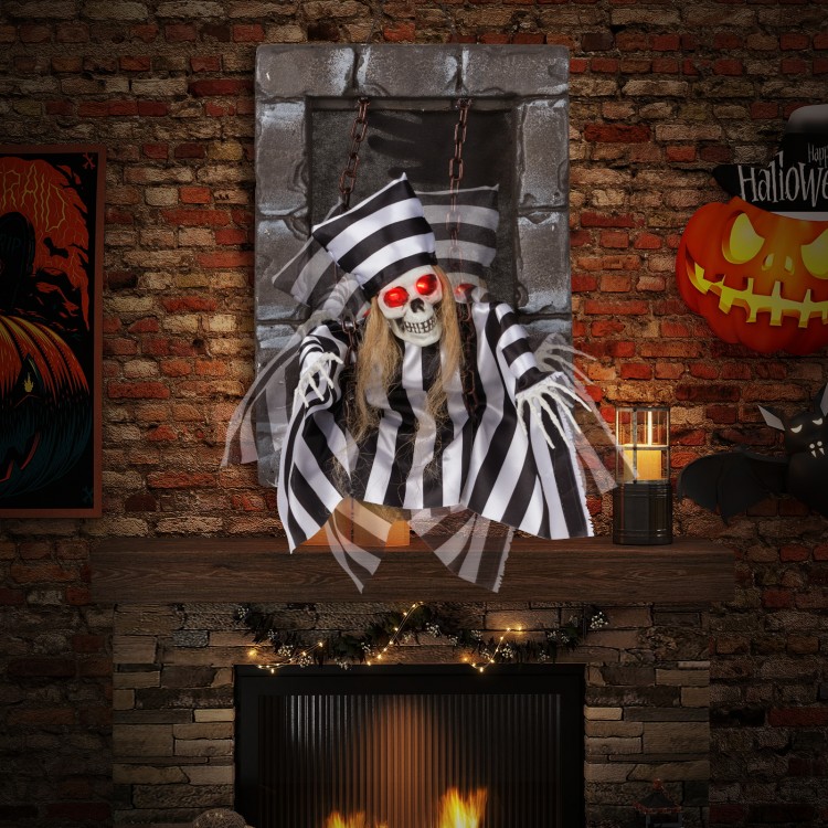 Hanging 18-inch animated skull prisoner decoration with LED eyes and sound effects, perfect for Halloween displays.
