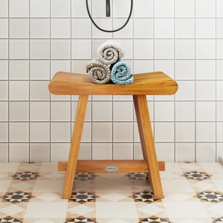 Teak shower bench with curved seat, featuring solid construction and water resistance, ideal for shaving legs or as a.