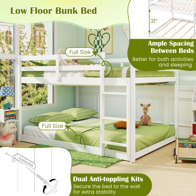 Full over full low-to-ground bunk bed in white with ample spacing, guardrails, and integrated ladder for safety.