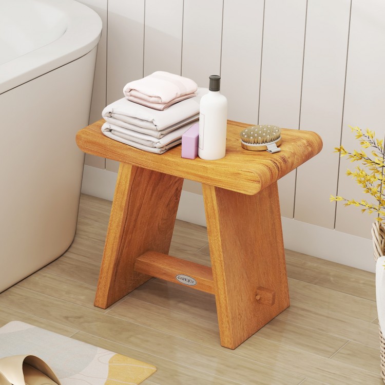 Teak shower bench with curved seat, water-resistant finish, ideal for shaving legs or as a side table in tight spaces.