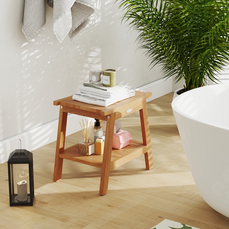 Teak wood shower bench with storage shelf, curved seat design, and adjustable foot pads for stability in the bathroom.