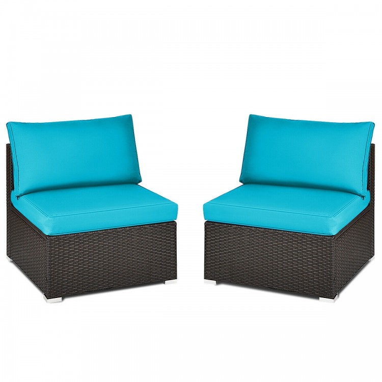 Two armless patio chairs with blue cushions, made of hand-woven rattan, perfect for outdoor relaxation.