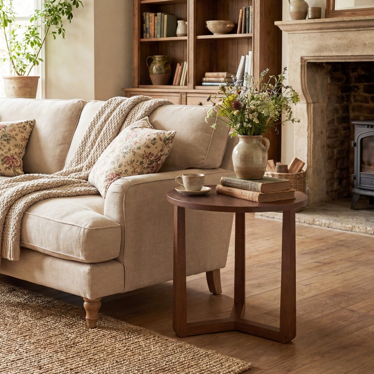 Round side table with sturdy rubber wood legs in walnut finish, perfect for rustic farmhouse living rooms or bedrooms.
