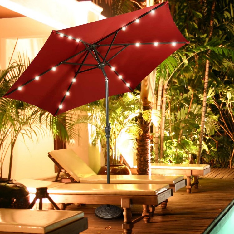 Heavy duty round umbrella base stand with bronze finish, securely holding an umbrella for outdoor relaxation.