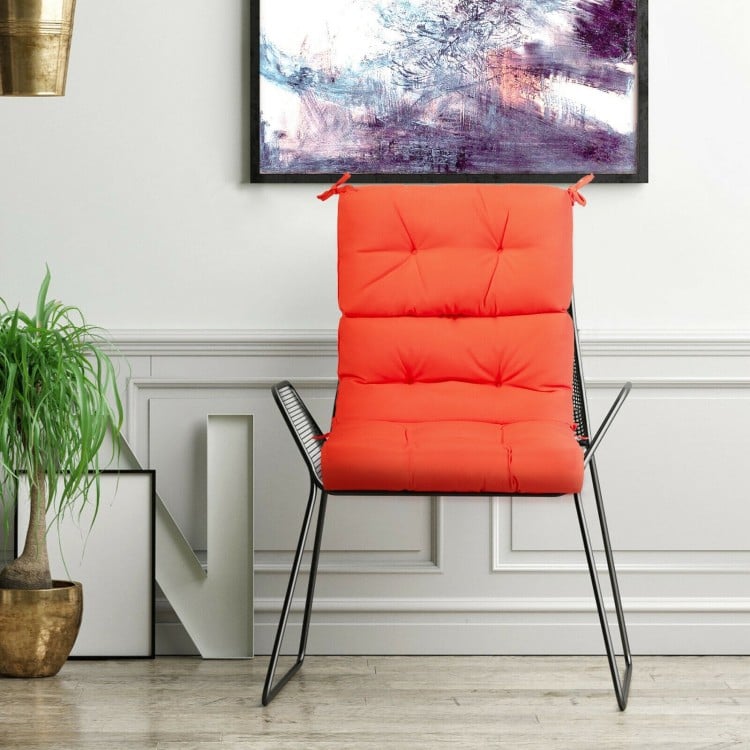 Tufted orange outdoor patio chair cushion with string ties for non-slip use, ideal for indoor and outdoor relaxation.
