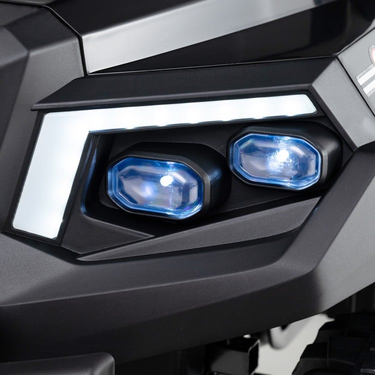 Close-up of the headlights on a black 24V kids golf cart, featuring blue accents and modern design for fun outdoor play.