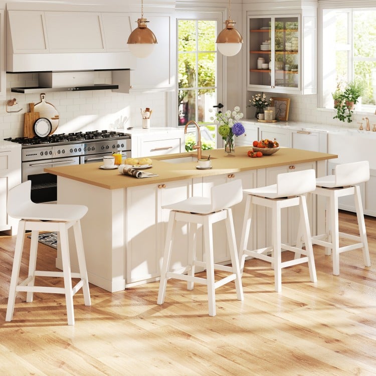 Set of four 24.5-inch white swivel wooden bar stools with rubber wood legs, perfect for dining areas and casual.