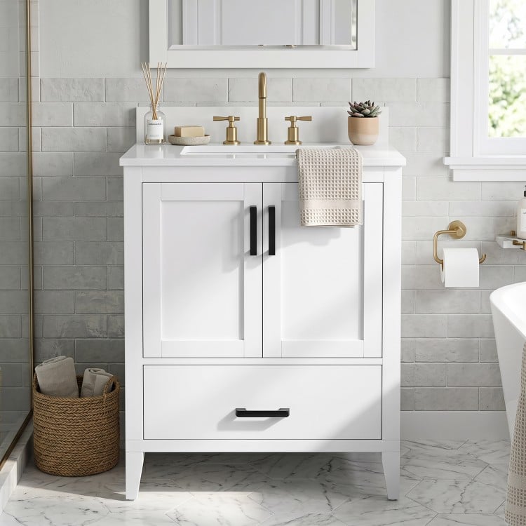 Modern 24.5" white bathroom vanity with a sleek design, featuring a bottom drawer with removable dividers for organized storage.