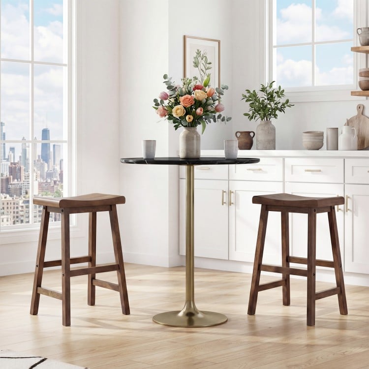 Two 24-inch brown solid wood saddle bar stools with ergonomic seats and footrests, ideal for kitchen island seating.