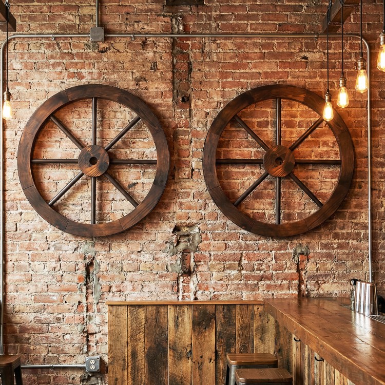 Decorative 24-inch wooden wagon wheels in carbonized fir wood, enhancing rustic charm on walls or barn doors.