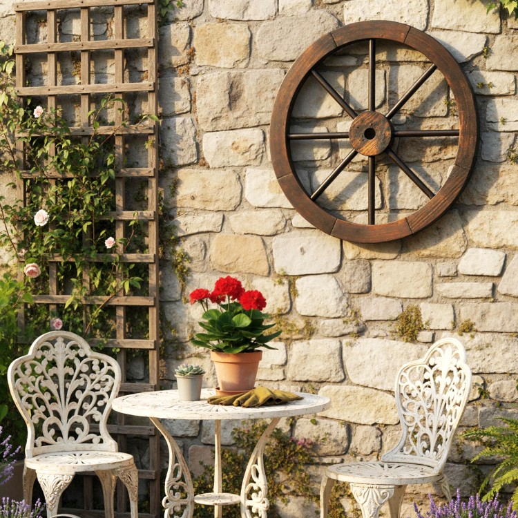 Decorative 24-inch wooden wagon wheel in a rustic setting, enhancing outdoor charm with a carbonized finish.