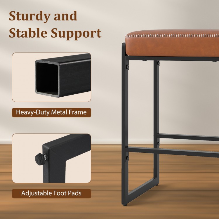 Close-up of the sturdy metal frame and adjustable foot pads of the 26-inch bar stools set for kitchen islands.