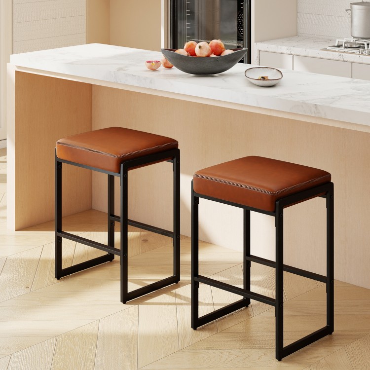 Set of 2 brown 26-inch bar stools with faux leather seats and sturdy metal frames, perfect for kitchen islands.