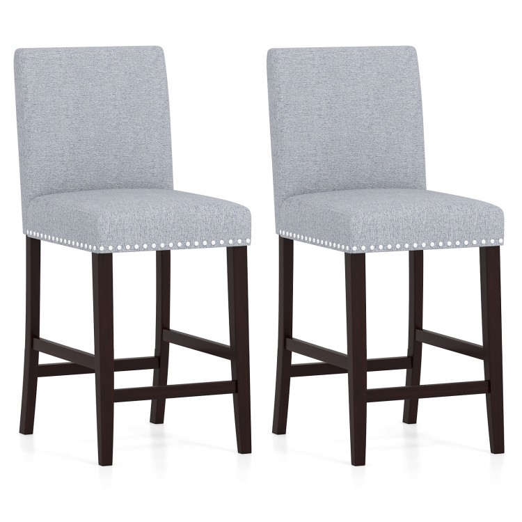 Set of 2 gray counter height chairs with padded seats, backrests, and elegant nailhead trim for kitchen or bar use.