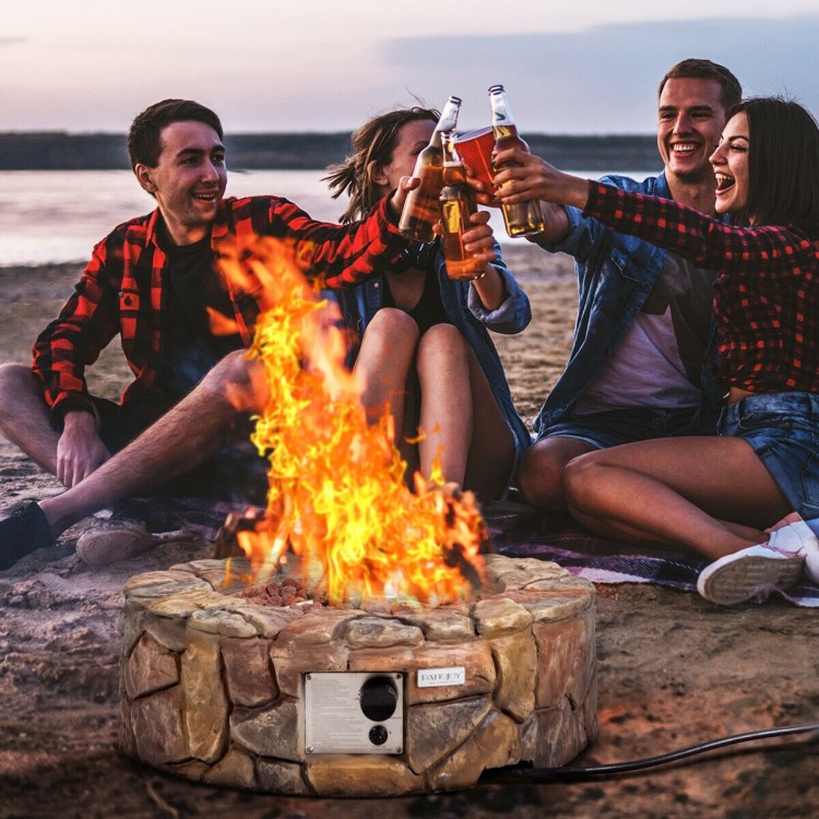 Round 28-inch propane gas fire pit with natural stone finish, providing 40,000 BTU for outdoor gatherings and warmth.