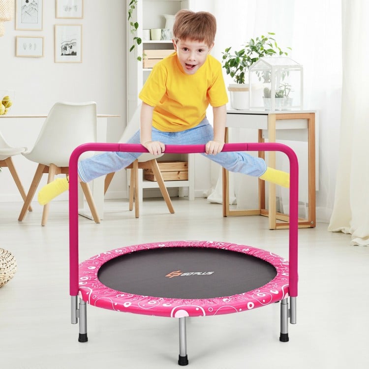 Kids trampoline with pink padded cover and full handrail, designed for safe indoor bouncing and energy release.