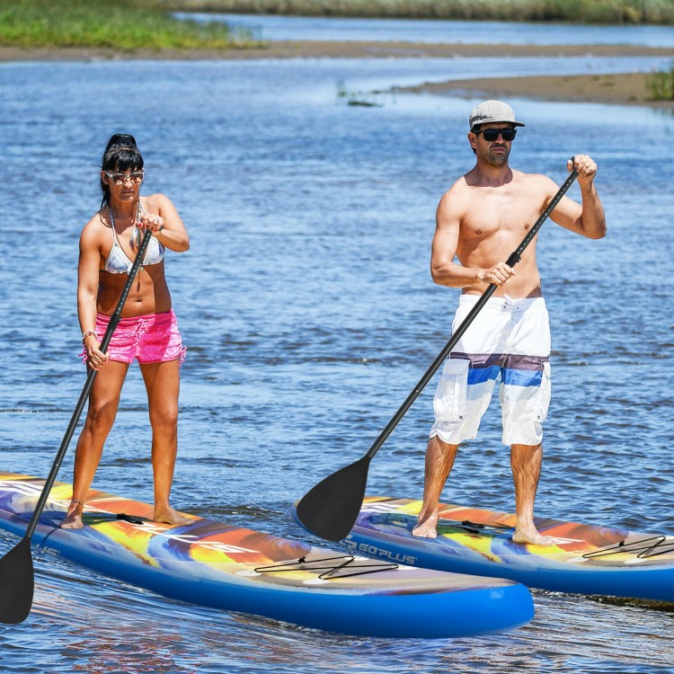Two people paddle on inflatable stand-up paddle boards in a serene water setting, ideal for water sports and yoga.