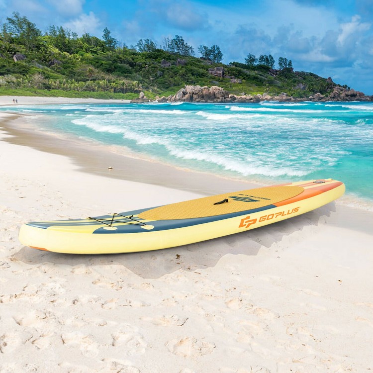 Inflatable stand-up paddle board on the beach, featuring a non-slip deck and bungee cords for secure storage.