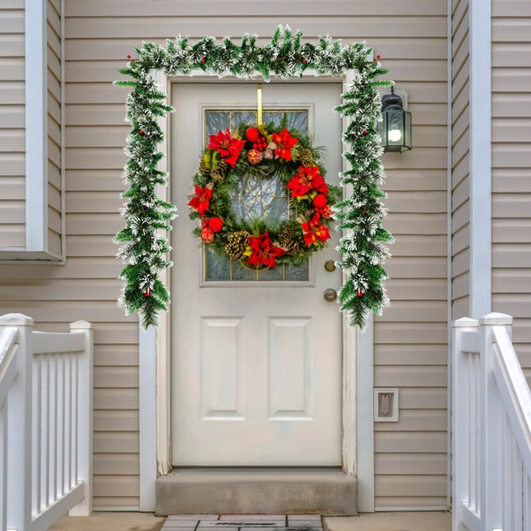 9-foot pre-lit Christmas garland adorned with snow-flocked tips and red berries, ideal for cheerful holiday decoration.