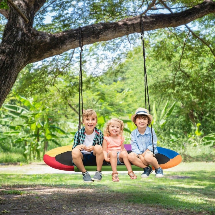 Oval 60-inch multicolor saucer swing with three children enjoying outdoor play, adjustable height for various spaces.