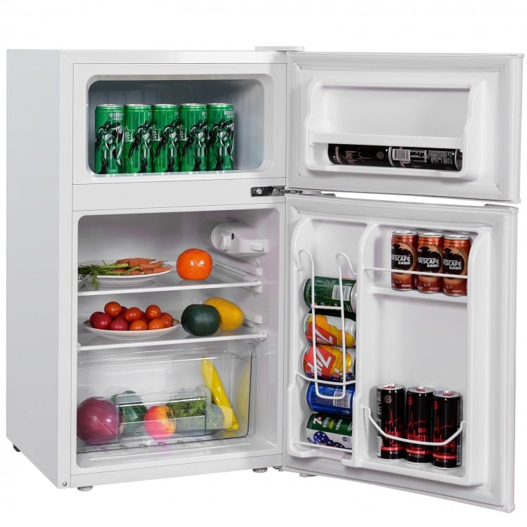 Compact stainless steel refrigerator showcasing a crisper drawer and can dispenser, perfect for organizing fresh foods.
