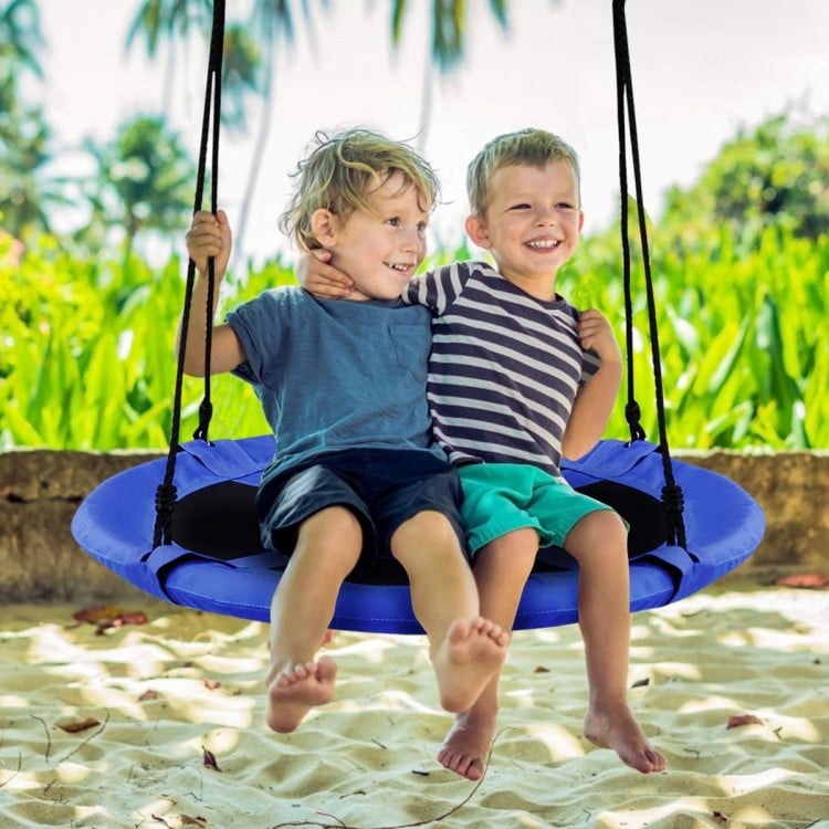 Two children enjoying the 40-inch blue flying saucer tree swing, perfect for outdoor play and relaxation.