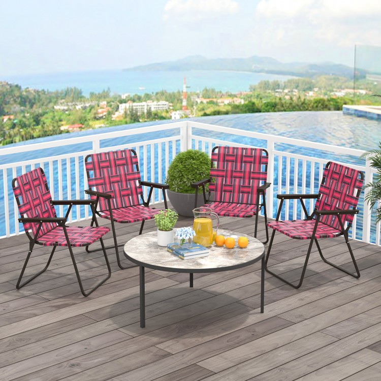 Four red folding beach chairs with a round table, perfect for outdoor gatherings and easy storage.