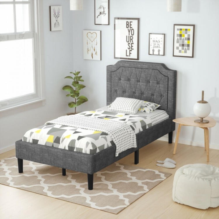 Twin upholstered platform bed with button-tufted headboard, gray fabric, and under-bed storage for a tidy room.