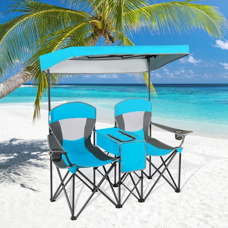 Double portable folding camping chairs with blue canopy and cup holders, perfect for beach or outdoor relaxation.