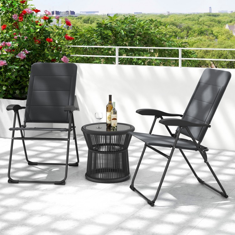 Two gray outdoor folding patio chairs with adjustable backrests and a round black side table on a balcony.