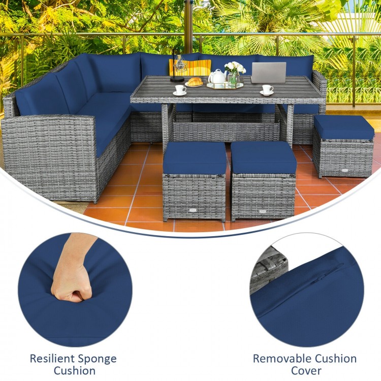 7-piece patio rattan dining set with navy cushions, featuring a table, corner chairs, and ottomans for outdoor.