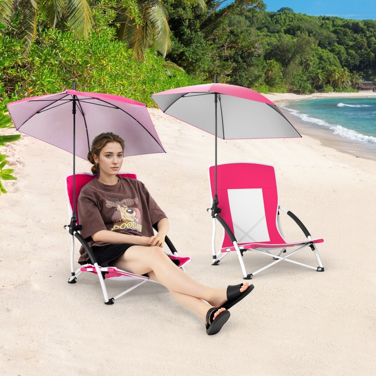 Two pink beach umbrella chairs with adjustable parasols, featuring UPF50+ protection, on a sandy beach.