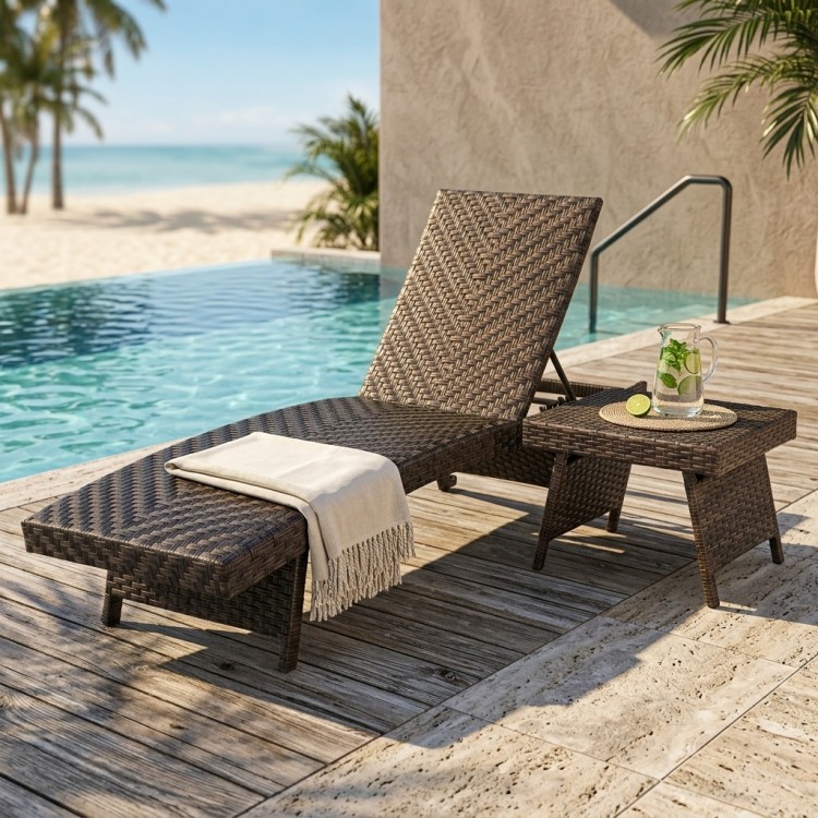 The 2-piece folding padded rattan patio chaise lounge set features a cushioned lounge and side table for outdoor relaxation.