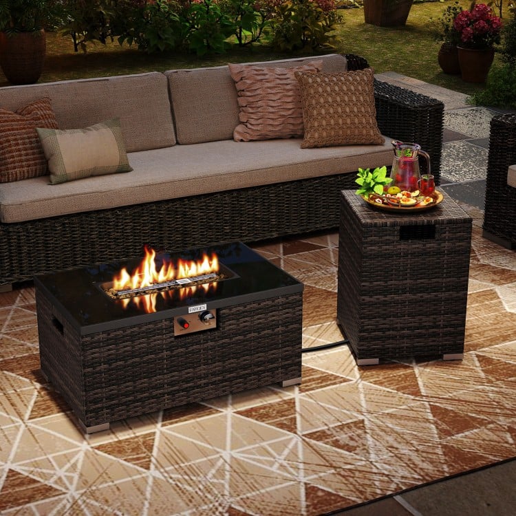 Outdoor rattan fire table set featuring a 32-inch gas firepit with a black tempered glass top for elegant outdoor.