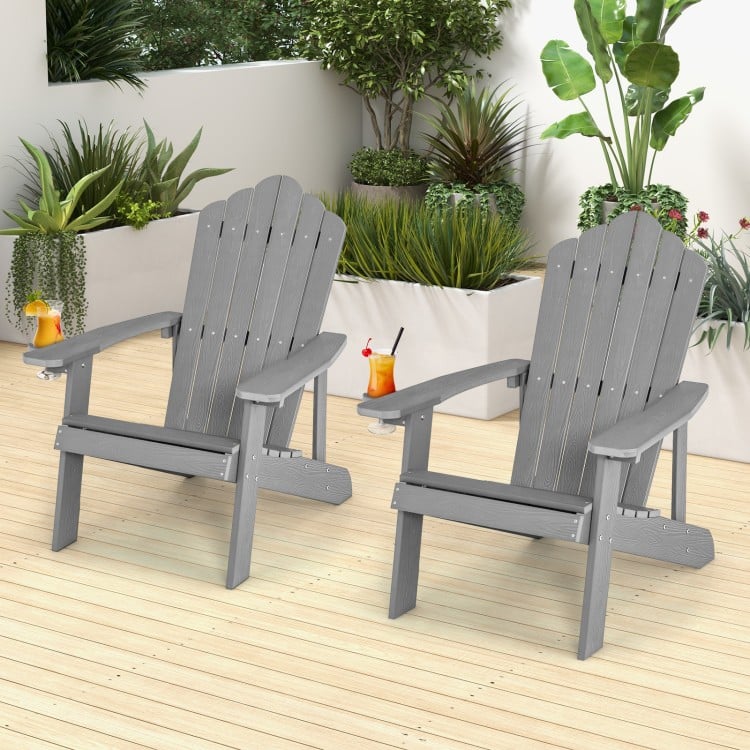 Two ergonomic silver Adirondack chairs set on a wooden patio, perfect for porch and backyard relaxation.