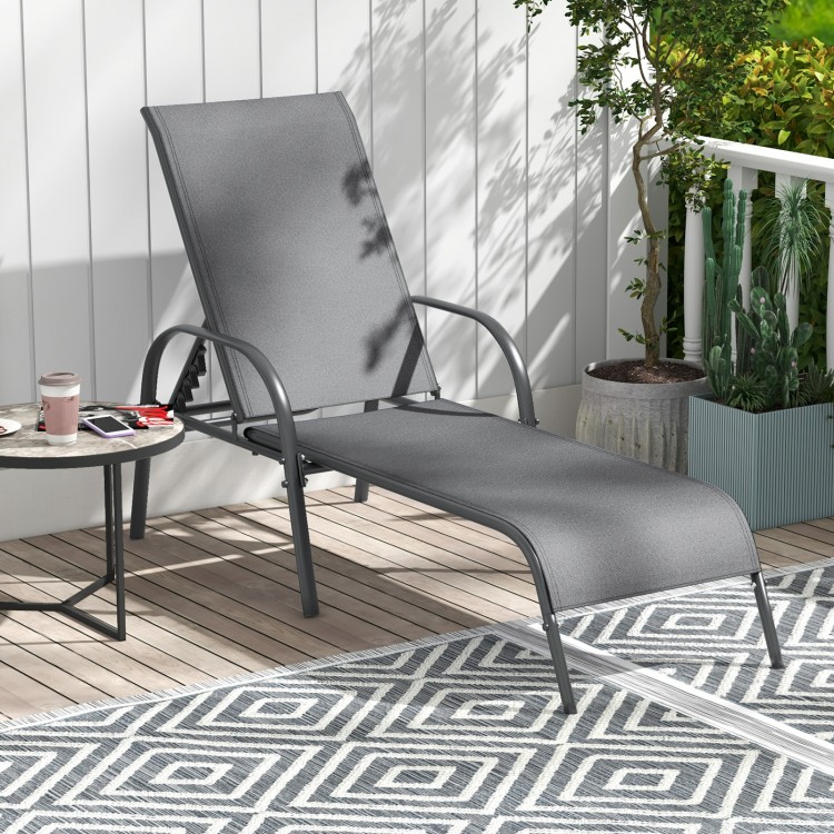 Dark gray outdoor patio lounge chair with adjustable reclining armrest, perfect for poolside or backyard relaxation.