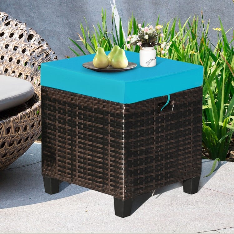 Turquoise cushion on a rattan ottoman with a sturdy steel frame, perfect for outdoor seating or as a coffee table.