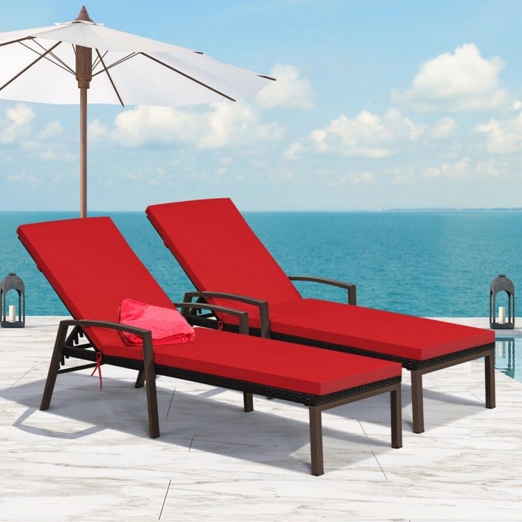 Red adjustable back lounge chairs with removable cushions, sturdy rattan, perfect for outdoor relaxation by the pool.