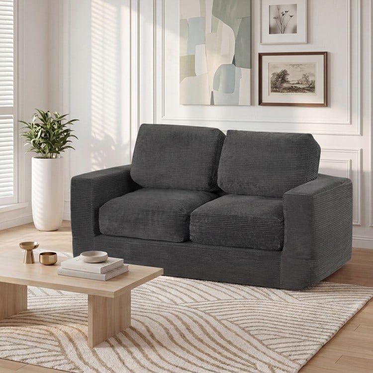 Black 2-seater floor couch loveseat with removable corduroy cover, featuring supportive foam filling for cozy lounging.