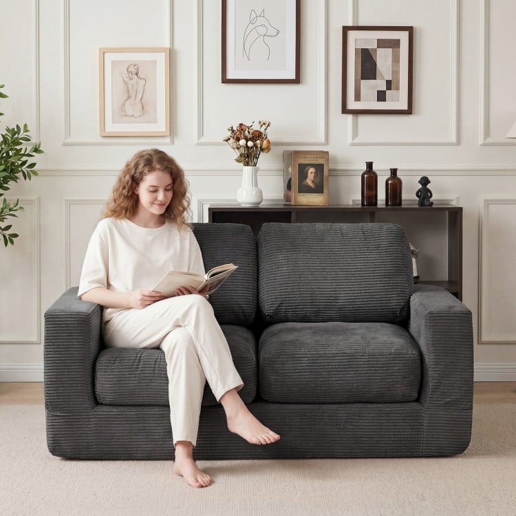 Black 2-seater floor couch loveseat with removable corduroy cover, ideal for cozy lounging in small spaces.