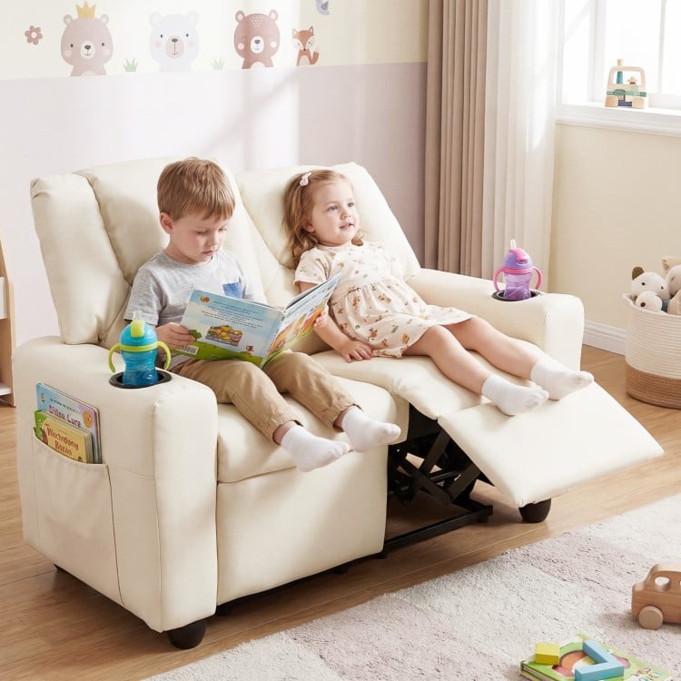 Beige 2-seater kids recliner sofa chair showcasing two toddlers reading comfortably with adjustable footrest and cup.