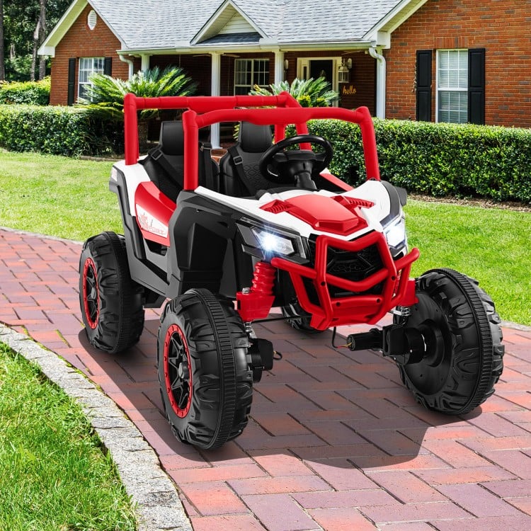 Red 2-seater kids UTV with remote control, safety belts, and bright headlights for outdoor fun on various surfaces.