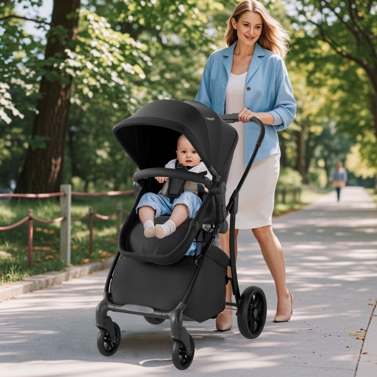 2-in-1 baby stroller in black with adjustable canopy, reversible seat, and large storage basket for easy transport.