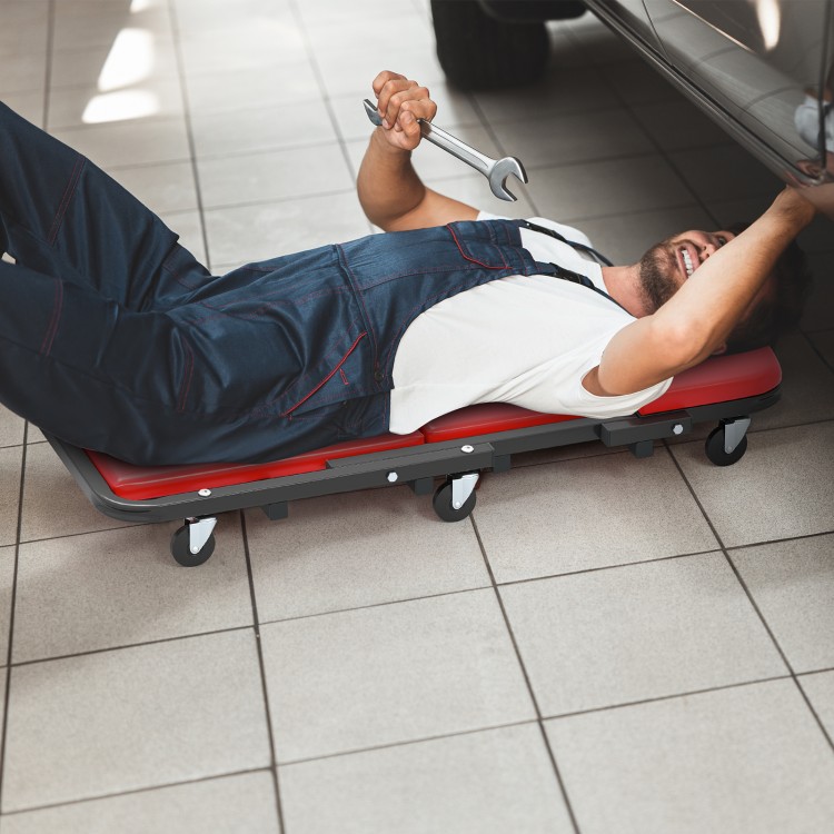 Low profile mechanic creeper with padded seat, red color, and 6 wheels, ideal for garage and auto repair tasks.