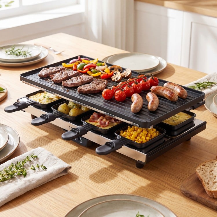 Reversible nonstick 2-in-1 table grill and griddle with 8 cheese pans, perfect for family gatherings and parties.