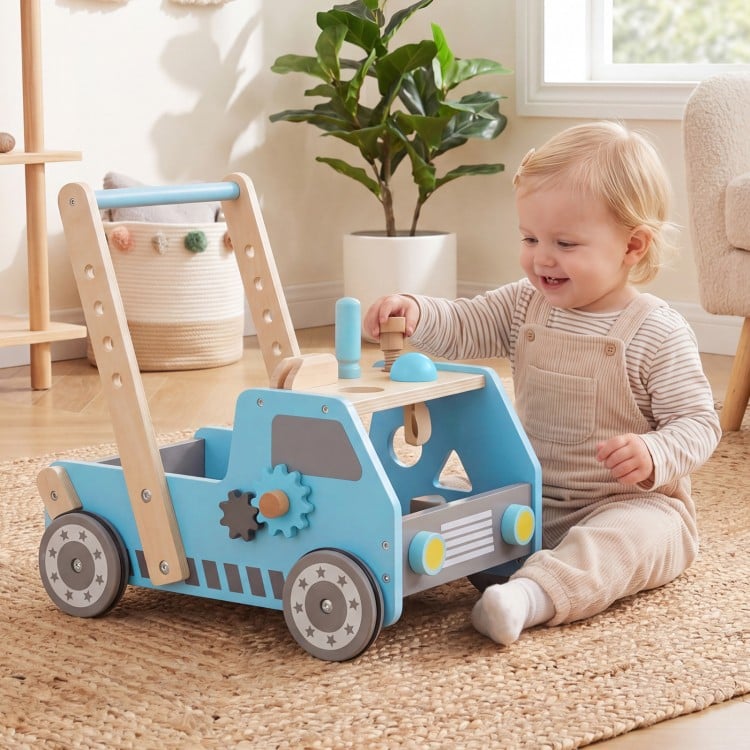 Blue truck-shaped wooden baby walker with adjustable speed, bottom storage, and rubber padded wheels for safe play.
