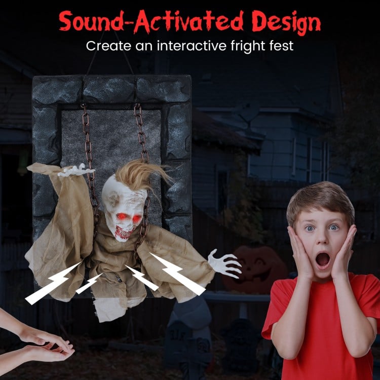 Sound-activated Halloween hanging animated zombie prisoner decoration with glowing red eyes and scary sounds for spooky.