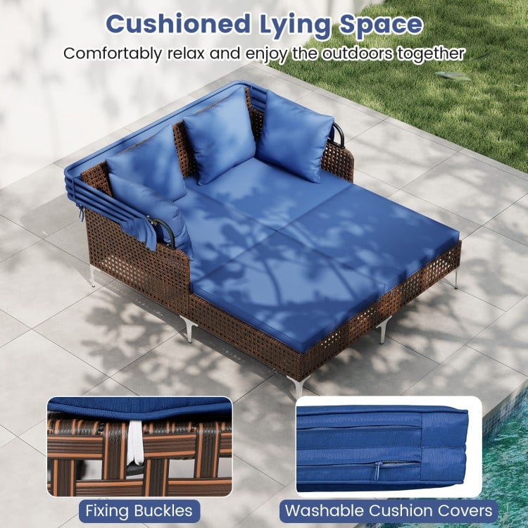 Cushioned outdoor daybed in navy with retractable canopy, made of PE wicker rattan, perfect for patio relaxation.