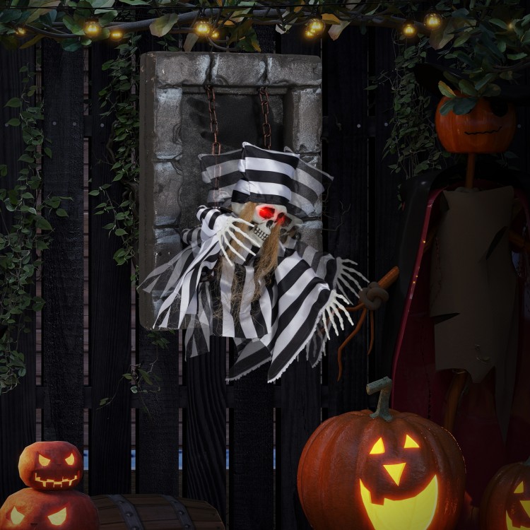 Hanging 18-inch animated prisoner skull decoration with LED eyes and sound effects for immersive Halloween displays.