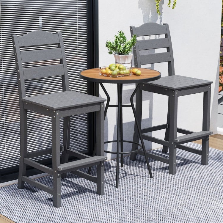 Gray 30-inch counter height HDPE bar stools with backrest and footrest, perfect for outdoor dining setups.